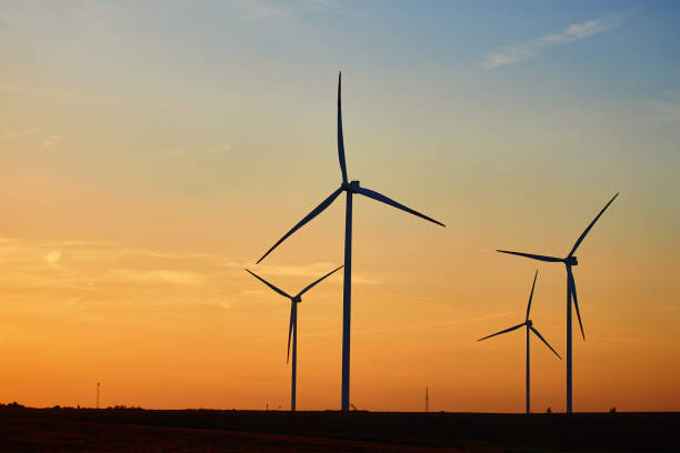 istock Silhouetted wind turbines in countryside landscape during sunset 2172171485