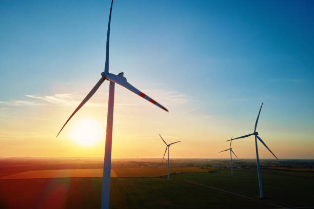 istock Silhouetted wind turbines in countryside landscape during sunset 2172171507