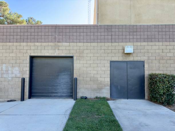 istock An industrial building typically features large, roll-up delivery doors for trucks, spacious interiors with high ceilings, and durable concrete floors, designed to facilitate the efficient movement of goods. 2172171740