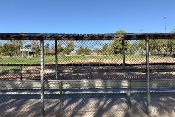 istock empty baseball dugout sits quietly beside the field, awaiting the next game, with benches, helmets, and bats neatly arranged in the peaceful lull between the action 2172171882