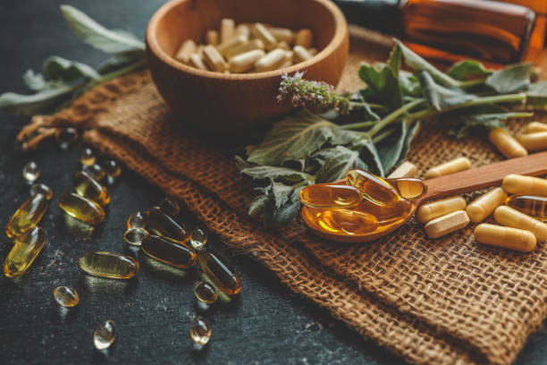 natural vitamins organic on dark background - vitamin foto potret stok, foto, & gambar bebas royalti