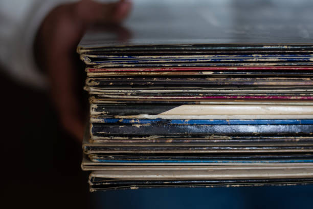 istock Woman  holding old vinyl retro records 2172179021