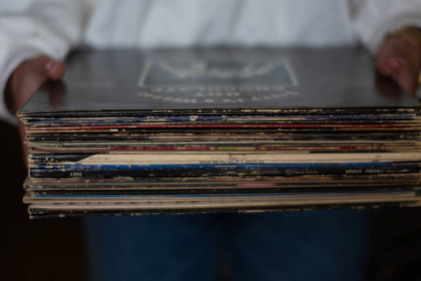 istock Woman  holding old vinyl retro records 2172179031