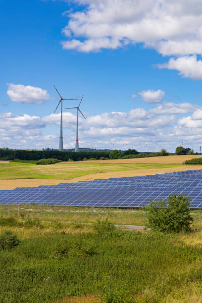 istock modern solar panels and wind turbines in a rural landscape 2172179853