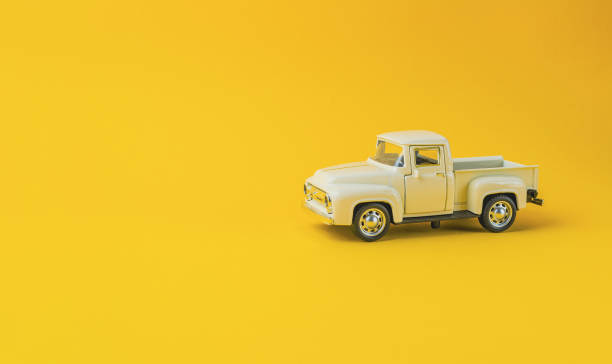 istock A toy truck is sitting on a yellow background 2172182026