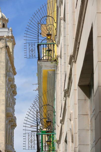 Balconies of iron lateral railings with arrowhead finials -right side- and Edificio Gomez Vila Building -left side- on Brasil Street. Havana-Cuba-702