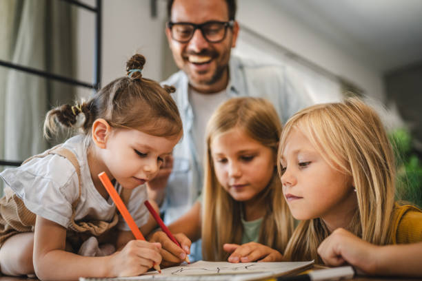 istock three young daughters draw and color in the notebook at home 2172183660
