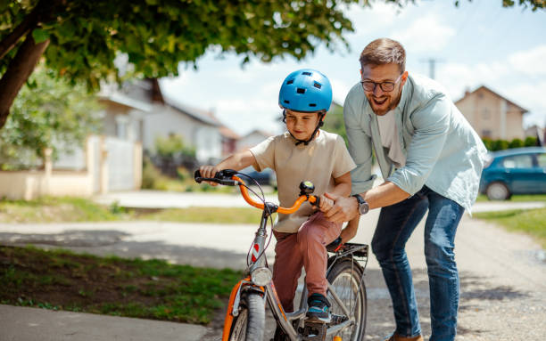 istock Father teaching his child to ride a bike 2172188583