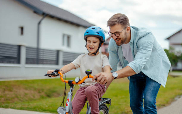 istock Father teaching his child to ride a bike 2172188702