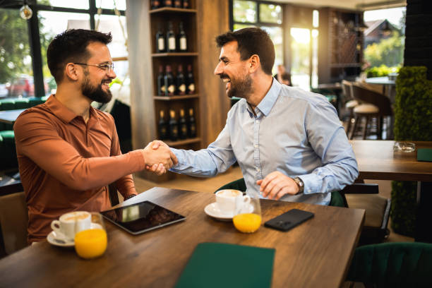 istock Two colleagues hanging out at the coffee shop. Working together on tablet. 2172195794
