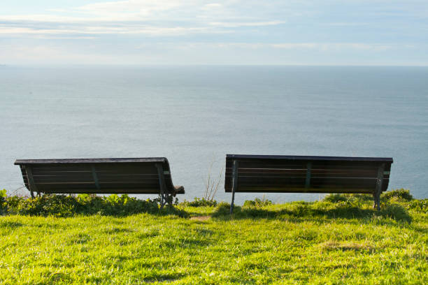 Estaca de Bares, northernmost point of Spain and the Iberian Peninsula, a rocky headland .Galicia , A Coruña province, Spain. Viewpoint, two empty  benches looking at view.