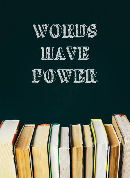 A stack of books with the words Words have power written above them. The image conveys the idea that words can have a significant impact on people and the world around us