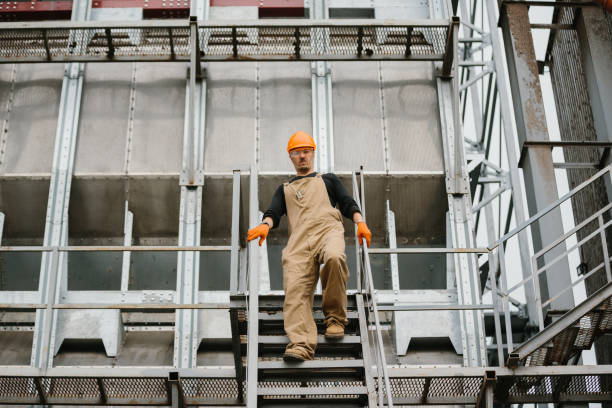 istock An industry worker descending the stairs on silo. 2172206885