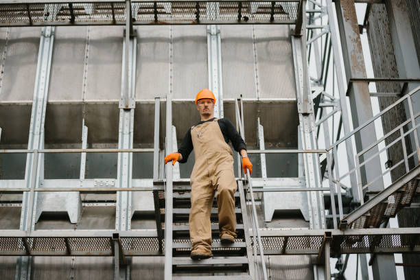 istock An industry worker descending the stairs on silo. 2172206888