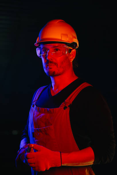 istock The assembly worker is illuminated by red neon light. 2172207026