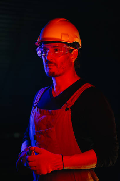 istock The assembly worker is illuminated by red neon light. 2172207031