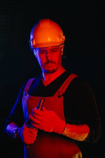istock The assembly worker is illuminated by red neon light. 2172207047