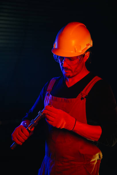 istock The assembly worker is illuminated by red neon light. 2172207051
