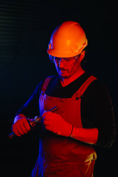 istock The assembly worker is illuminated by red neon light. 2172207057