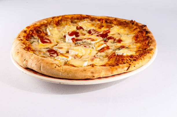 istock A pizza with cheese and tomato sauce sits on a white plate 2172209356