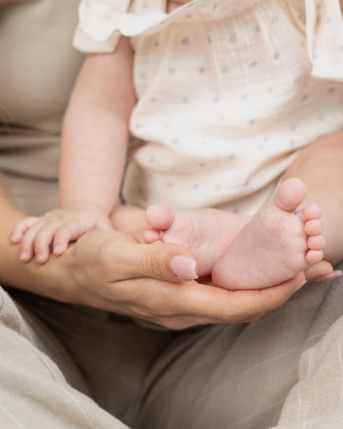 istock baby's bare feet in father's arms 2172213375