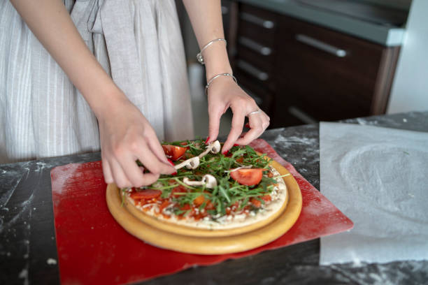 istock Woman preparing a tasty pizza 2172214356