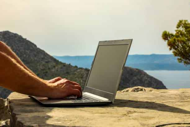 istock A programmer works remotely on a laptop in the summer high in the mountains (part of the series 