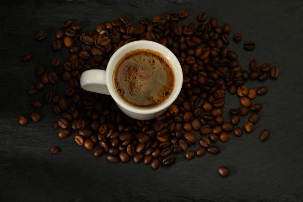 istock Close-up of coffee cup with beans on table 2172221186