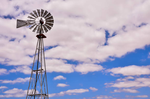 istock A windmill is standing tall in the sky above a blue sky 2172232581