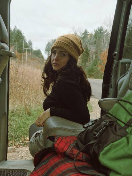 istock Adventurous woman backpacking on a rural road. 2172234683