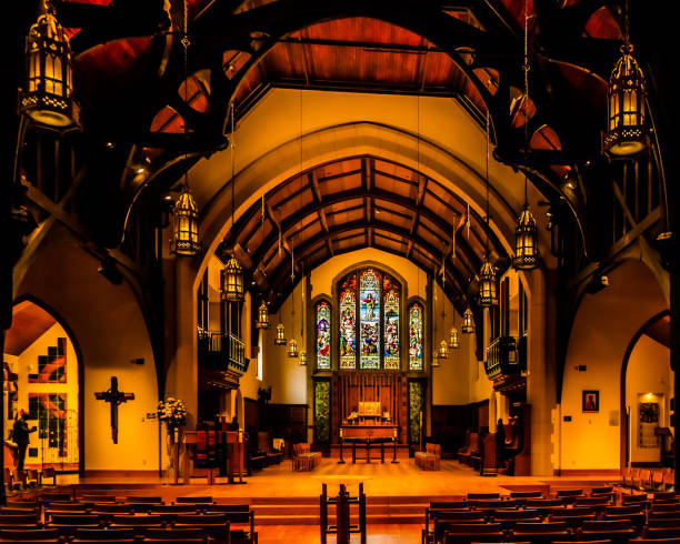 Church Pew Empty with Shimmering Colorful Light From Stained Glass Window - Colorful light patterns on empty pew seat in large cathedral church.