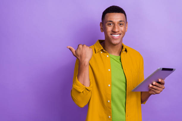 istock Photo of young man hold device empty space instagram telegram twitter facebook dressed yellow outfit isolated on violet color background 2172235198