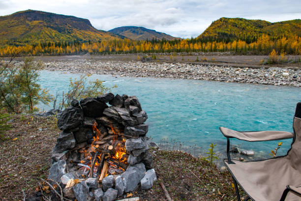 istock Camp fire by a flowing river with autumn colours in Canada 2172240877