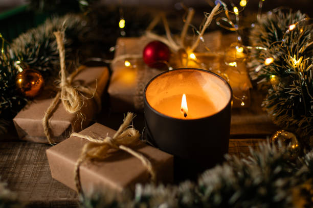 istock Christmas presents under the tree with a decorative candle. 2172241615
