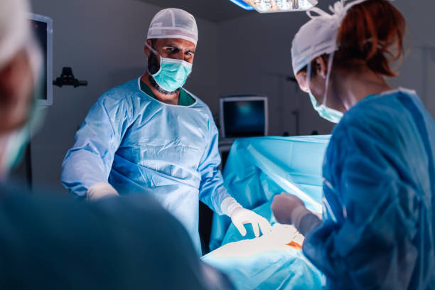 istock Surgeons dedicatedly perform intricate operation in sterile room. 2172254018