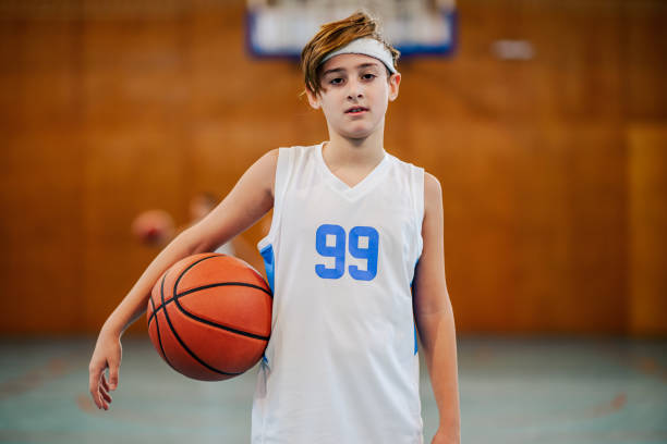 istock Youth basketball player posing with ball 2172254077