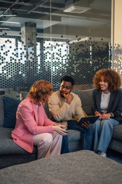 istock Interracial businesspeople with tablet discussing digital marketing. 2172254101