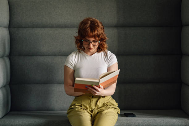 istock Millennial businesswoman with textbook in hands writing creative text. 2172254114