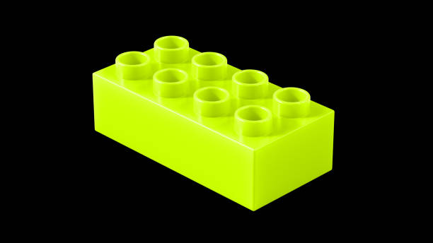 Lime Green Plastic Toy Block Isolated on a Black Background.