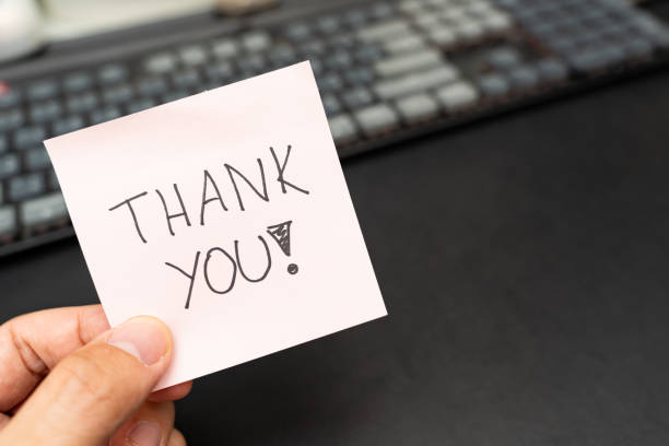 istock Hand holding a pink sticky note with THANK YOU text. Copy space. 2172268304