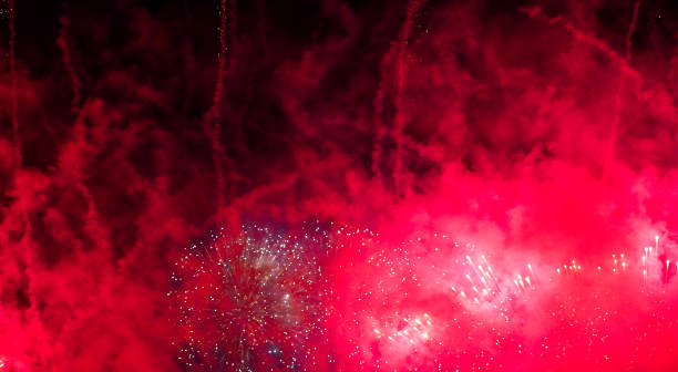 Red fireworks bloom on the dark sky