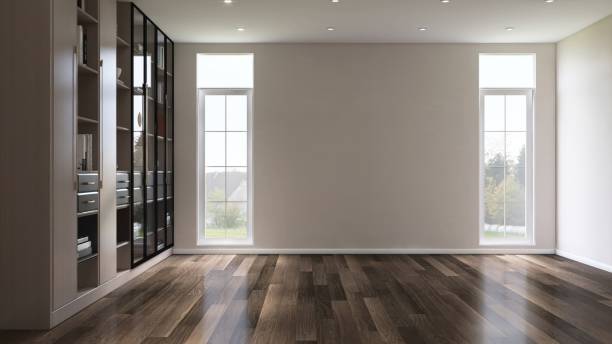 istock Empty room with beige brown wall in sunlight on dark brown parquet floor from white frame glass window to courtyard with tree 2172278935
