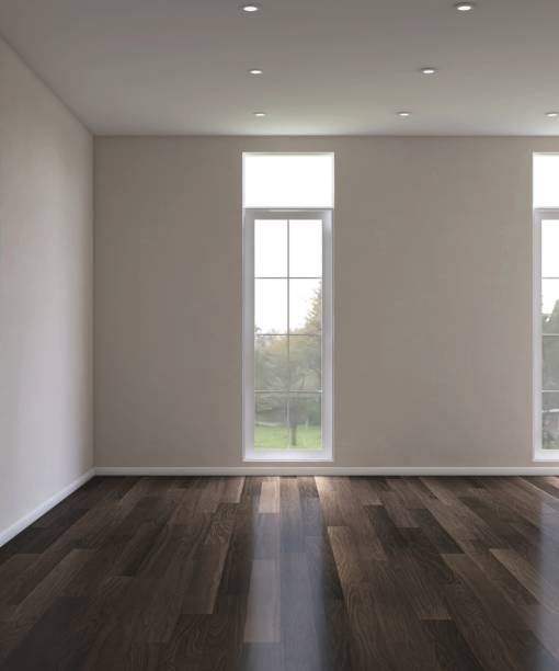 istock Empty room with beige brown wall in sunlight on dark brown parquet floor from white frame glass window to courtyard with tree 2172278939