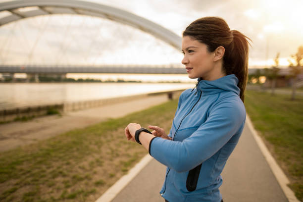 istock Athletic woman using smart watch while exercising outdoors in the morning. 2172289244