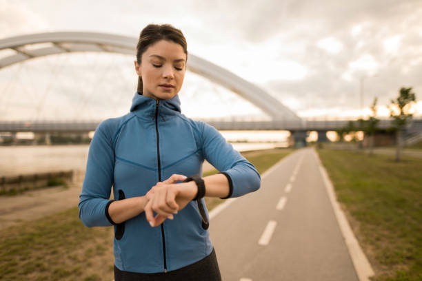 istock Athletic woman using smart watch while exercising outdoors in the morning. 2172289336
