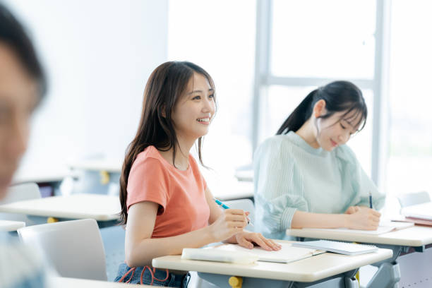 istock University student talking to classmates in classroom 2172291894