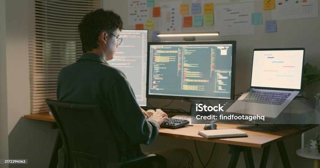 Developer Coding At Home Office With Multiple Screens Stock Photo ...