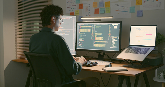 Developer Coding At Home Office With Multiple Screens Stock Photo ...