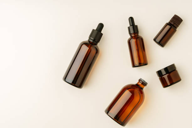 istock Various Amber Glass Containers for Essential Oils and Skin Care Products Displayed on Light Background 2172297582