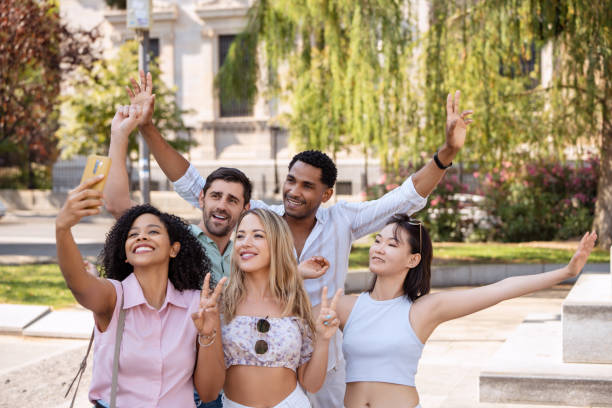 istock Group of friends taking a joyful selfie outdoors, smiling and striking fun poses. 2172297616